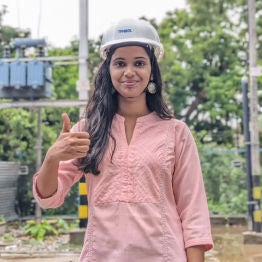 Woman wearing TPNODL cap giving thumbs up