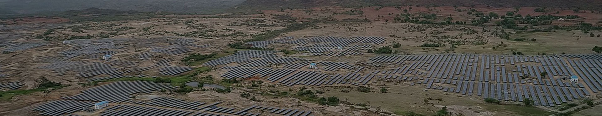 A Big Land With Solar Panels Near Mountains